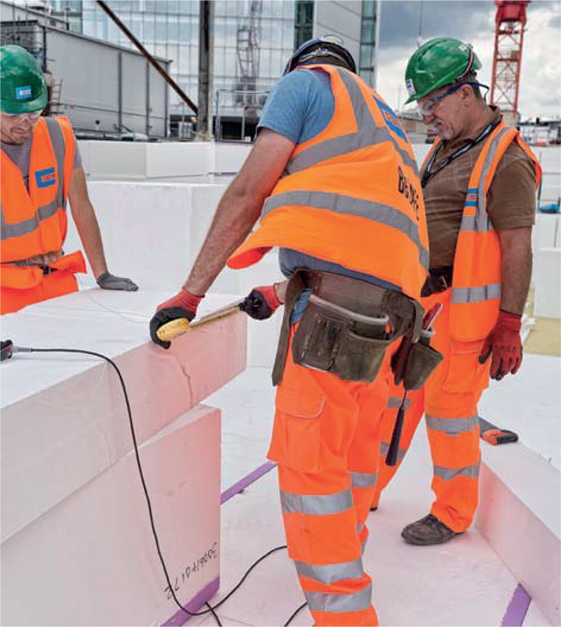Expanded polystyrene (EPS) blocks being cut to fit by means of a portable hot wire cutter